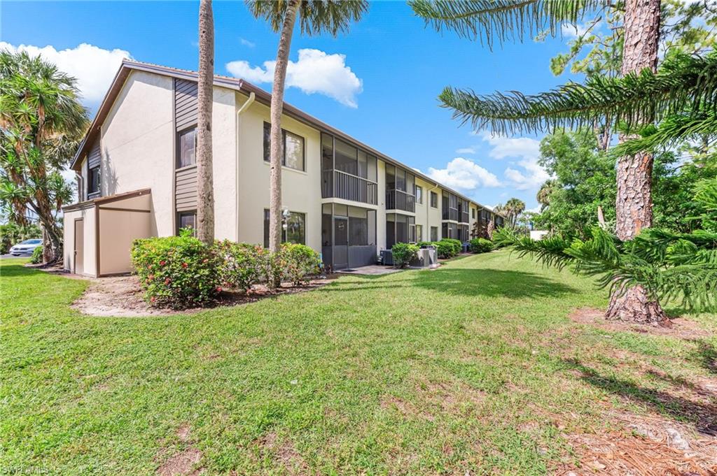 5857 Rattlesnake Hammock Road, Unit 208 Naples, FL 34113 - Photo 23 of 24 a view of backyard of house with green space