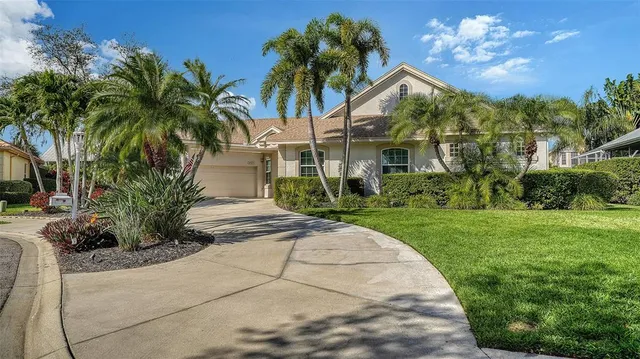 a front view of a house with a yard and potted plants