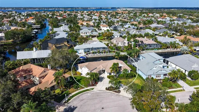 an aerial view of a house with yard swimming pool outdoor seating and lake view