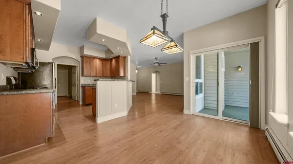 a view of a kitchen center island wooden floor and a window