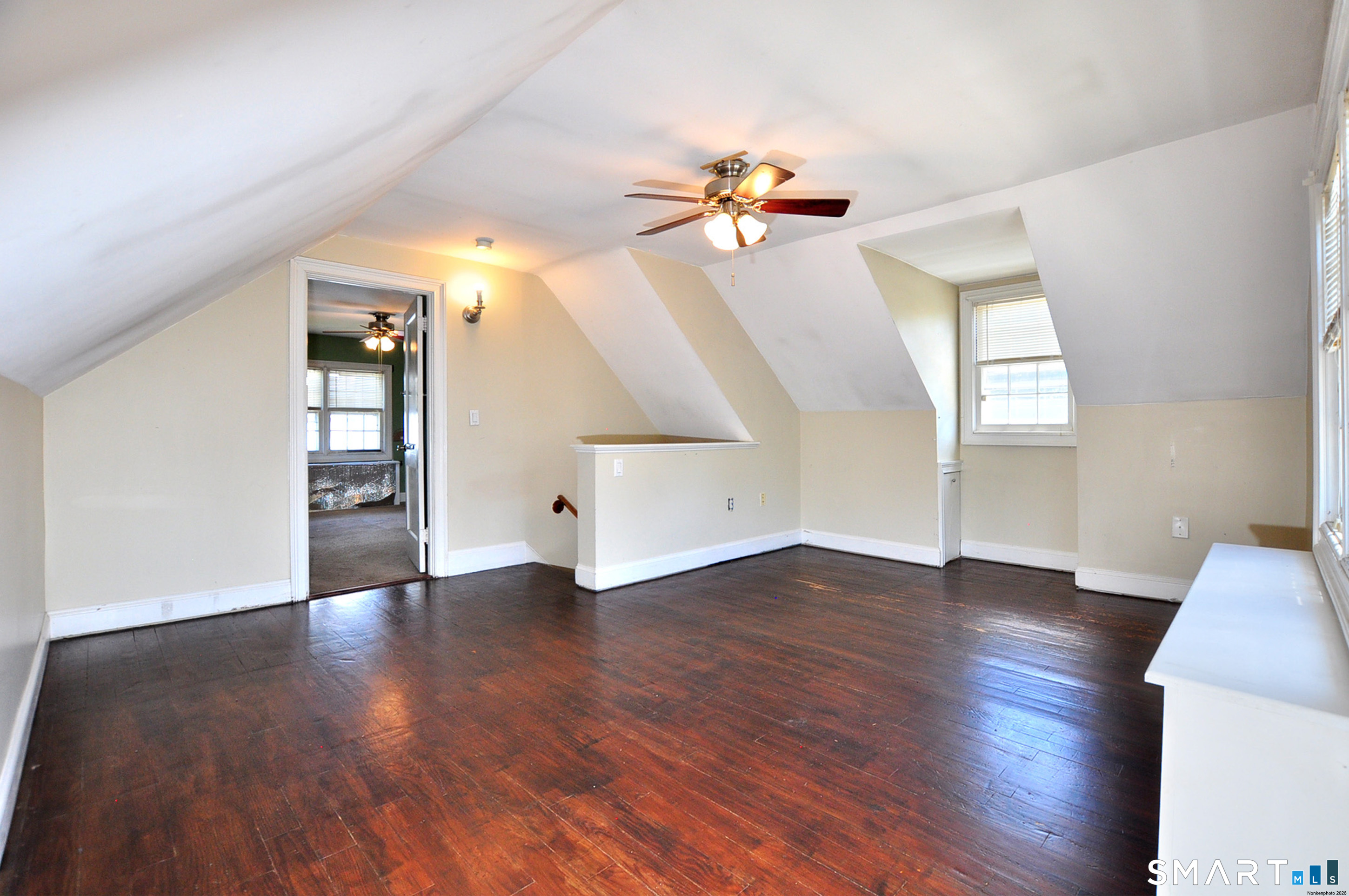 103 West Center Street Manchester, CT 06040 - Photo 29 of 29 an empty room with wooden floor and chandelier fan