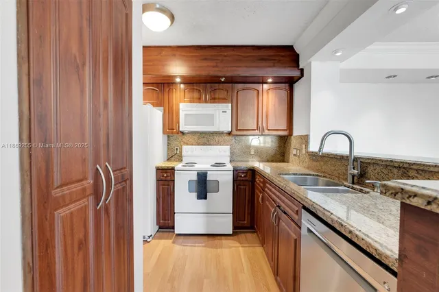 a kitchen with a sink and a stove top oven