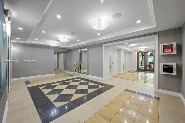 a lobby with a rug and glass door