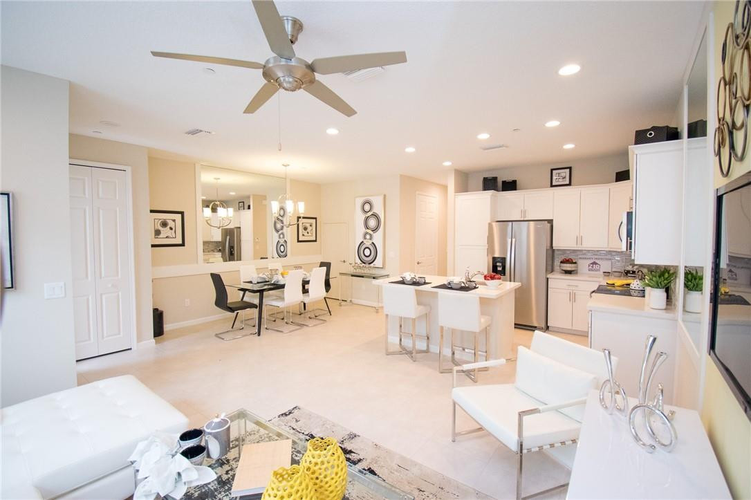 14377 Sims Road, Unit 9 Delray Beach, FL 33484 - Photo 1 of 8 a living room with lots of furniture and white walls