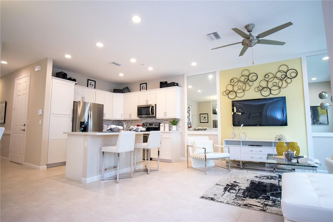 14377 Sims Road, Unit 9 Delray Beach, FL 33484 - Photo 2 of 8 a living room with furniture and a flat screen tv