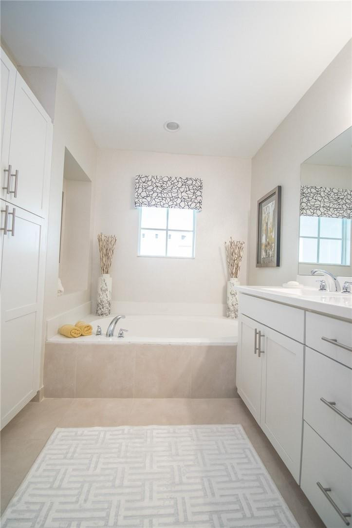 14377 Sims Road, Unit 9 Delray Beach, FL 33484 - Photo 7 of 8 a spacious bathroom with a tub sink and mirror