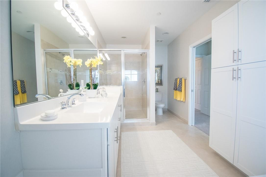 14377 Sims Road, Unit 9 Delray Beach, FL 33484 - Photo 8 of 8 a bathroom with a sink a mirror and a shower