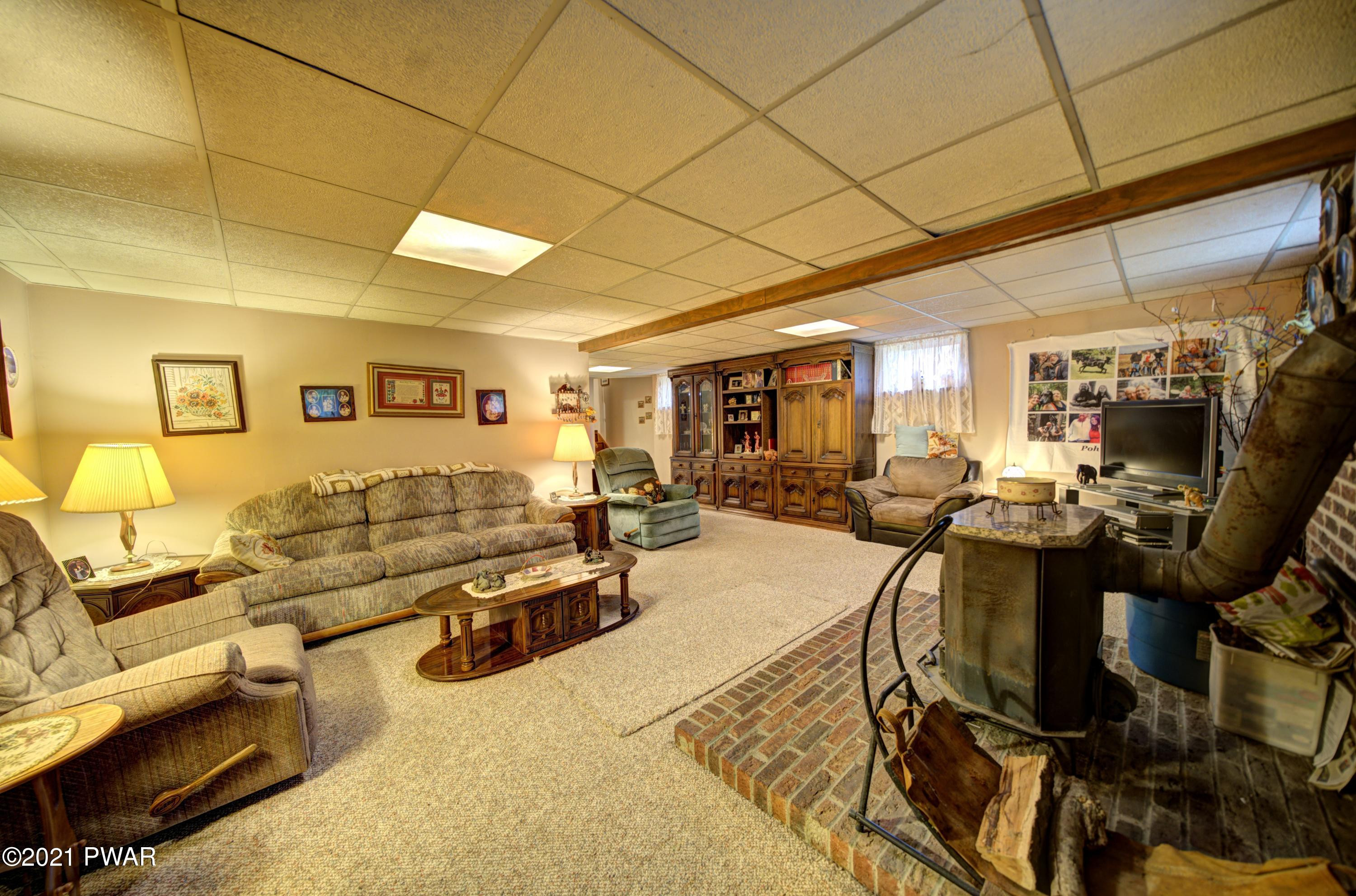 368 Roemerville Road Greentown, PA 18426 - Photo 19 of 59 a living room with lots of furniture and gym equipment