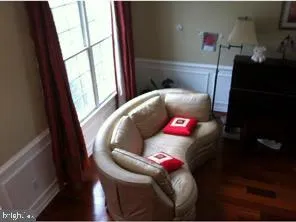 a living room with furniture and a floor to ceiling window