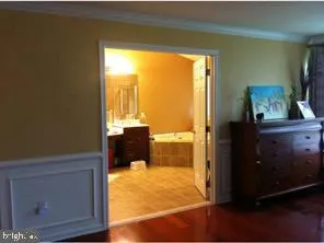 a view of a living room with a flat tv screen and a dresser