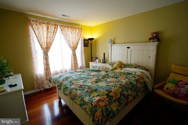 a bed sitting in a bedroom next to a window