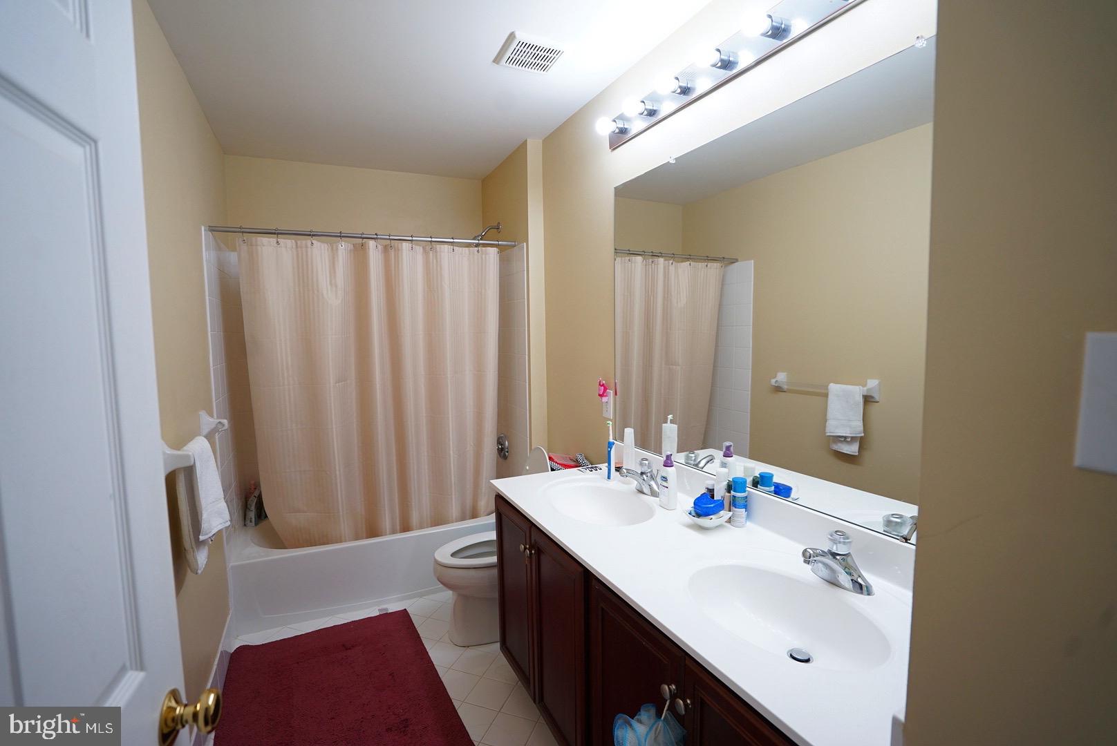 1203 Denton Drive Chester Springs, PA 19425 - Photo 27 of 31 a bathroom with a sink a mirror and a toilet