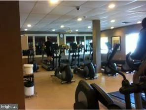 a room with gym equipment and a glass door