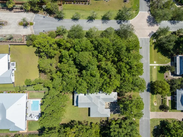 an aerial view of a house with a yard and lake view
