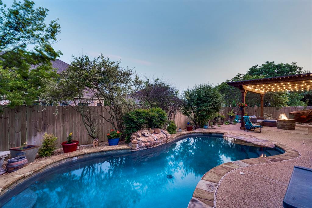 swimming pool view with a seating space and a garden view