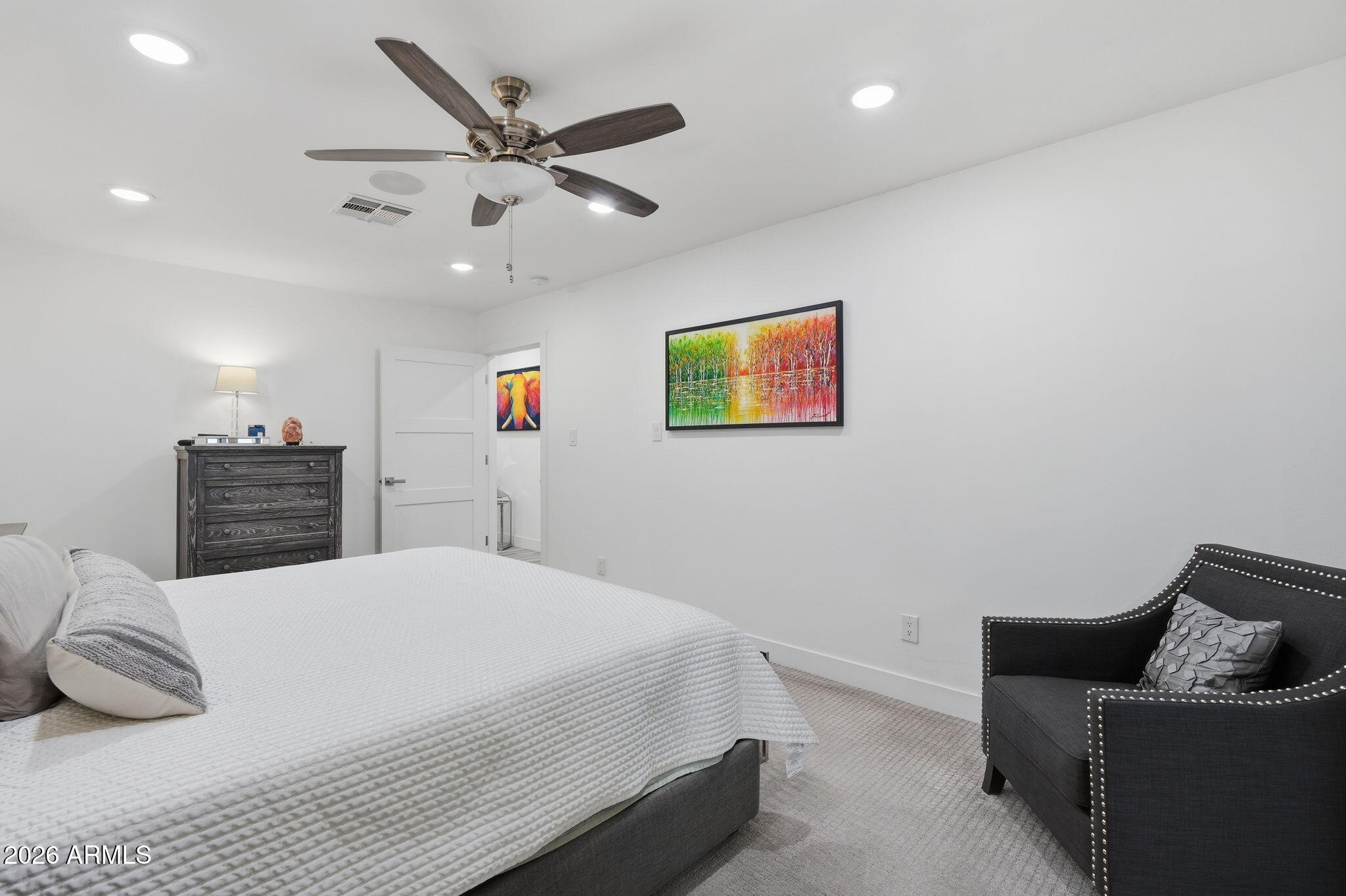 5149 North 34th Street Phoenix, AZ 85018 - Photo 30 of 70 a bedroom with a bed and ceiling fan