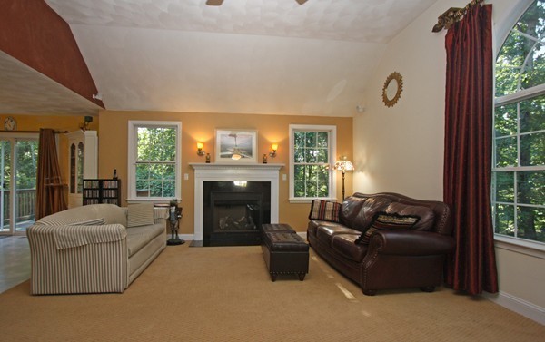 172 Scribner Road Tyngsborough, MA 01879 - Photo 9 of 17 a living room with furniture and a fireplace