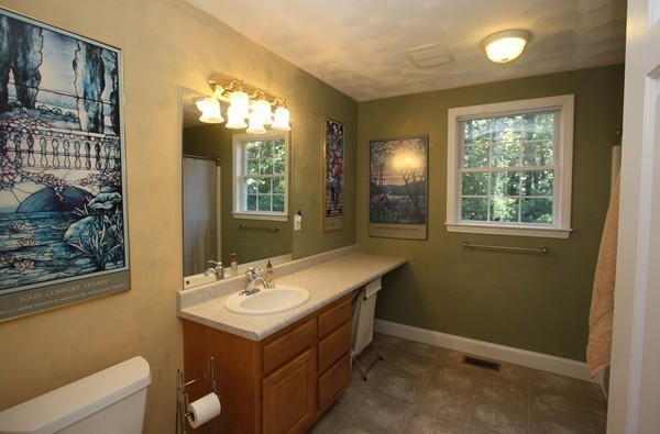 172 Scribner Road Tyngsborough, MA 01879 - Photo 10 of 17 a bathroom with a sink mirror and a window