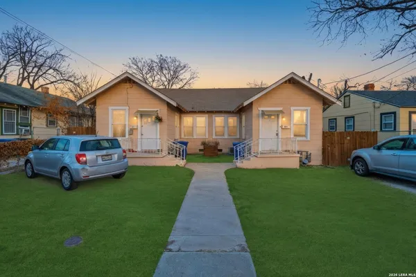 a front view of a house with a garden and yard