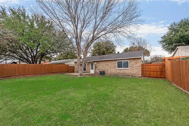 a front view of house with yard and trees