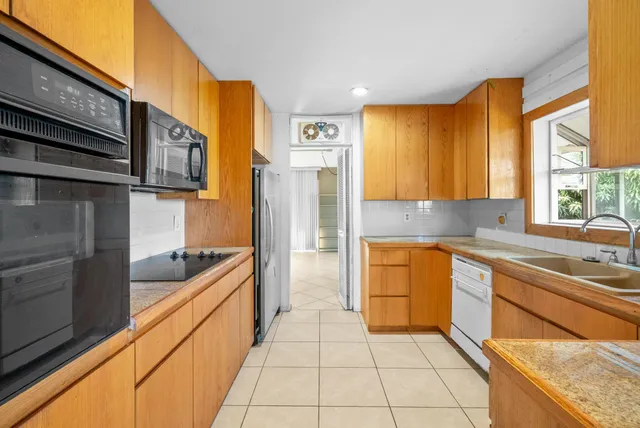 a kitchen with stainless steel appliances granite countertop a sink and cabinets