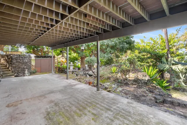 a view of an empty room with a walk in closet and wooden floor