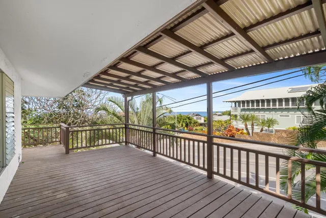 a view of a balcony with wooden floor