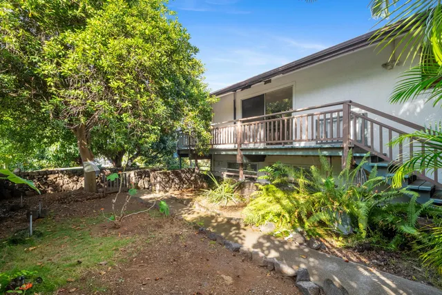 a backyard of a house with table and chairs