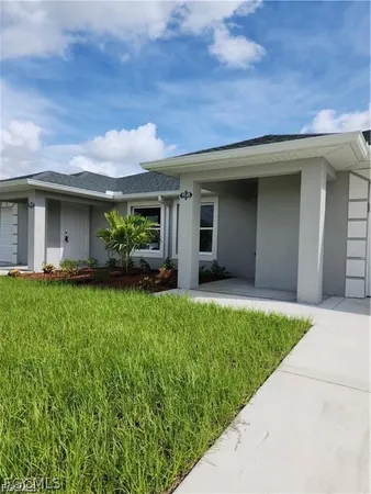 a front view of a house with a garden and plants