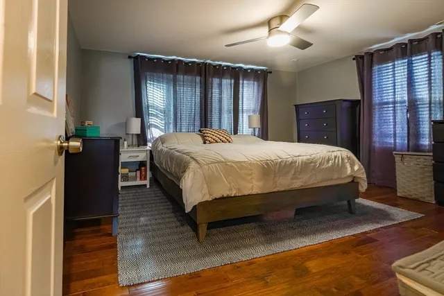 a bedroom with a large bed and a window