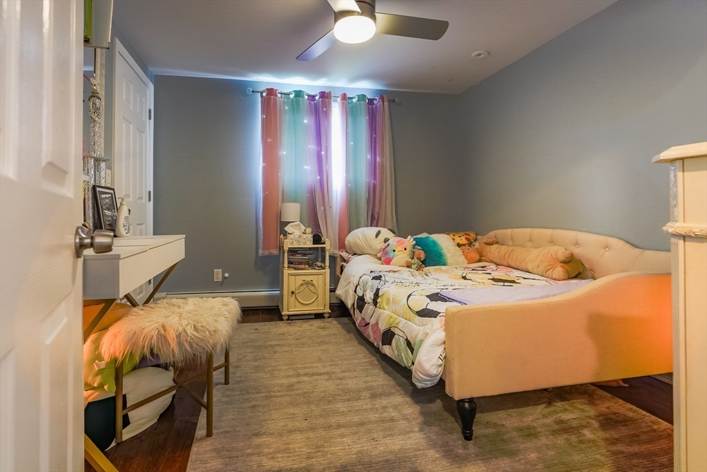 142 Norman Street Fall River, MA 02721 - Photo 14 of 25 a bedroom with a bed and a chandelier