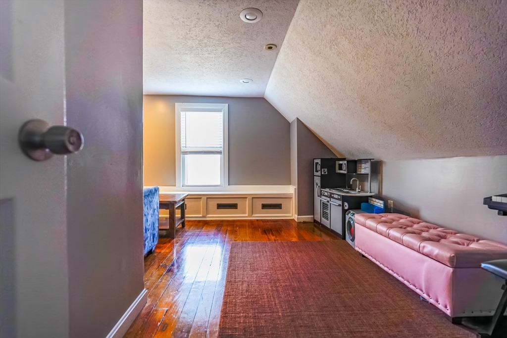 142 Norman Street Fall River, MA 02721 - Photo 16 of 25 a bedroom with furniture and a wooden floor