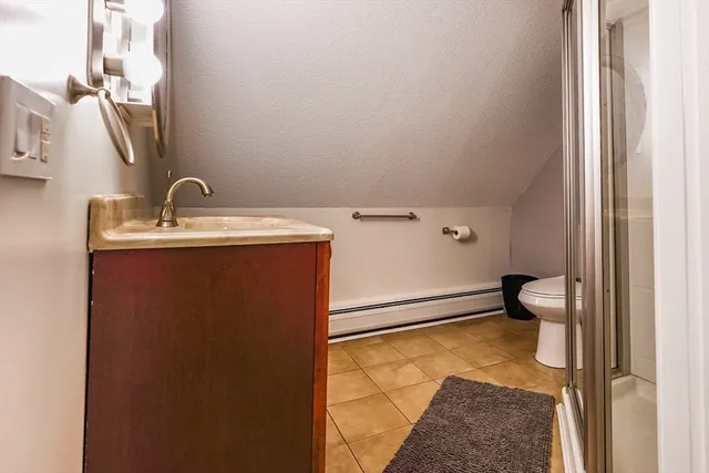 a view of a hallway with entryway wooden floor and cabinet