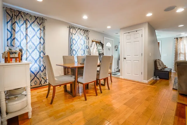 a view of a dining room with furniture and a chandelier