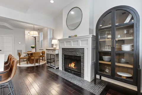 a living room with furniture a fireplace and wooden floor