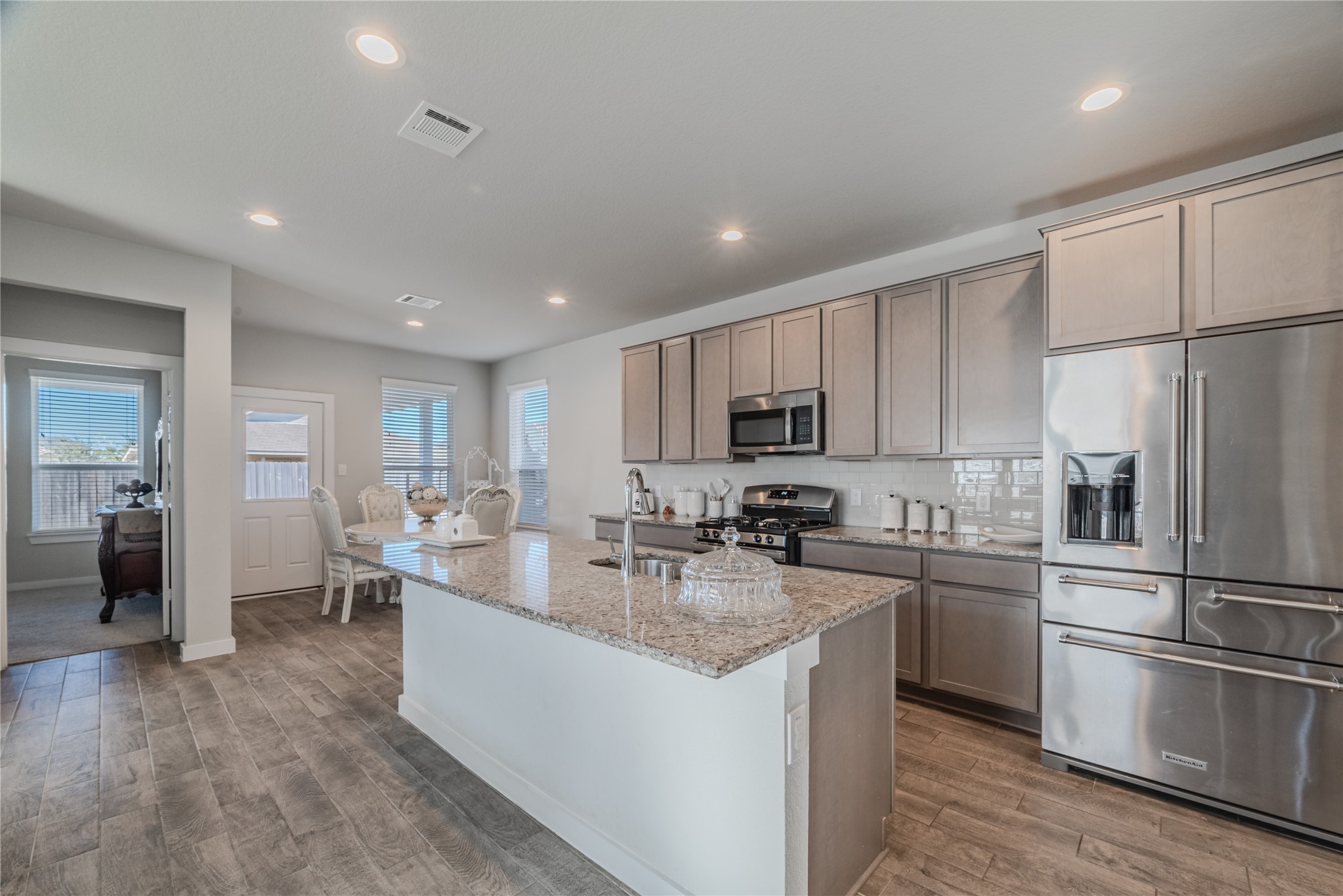 4259 Wyanngate Drive Spring, TX 77373 - Photo 12 of 46 The open-concept kitchen features premium granite countertops and a versatile island with breakfast bar seating