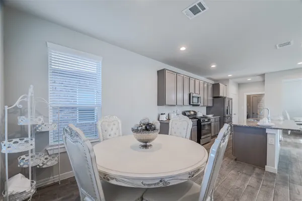 a large kitchen with a large counter top appliances and cabinets