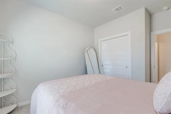 a large bed in a white room