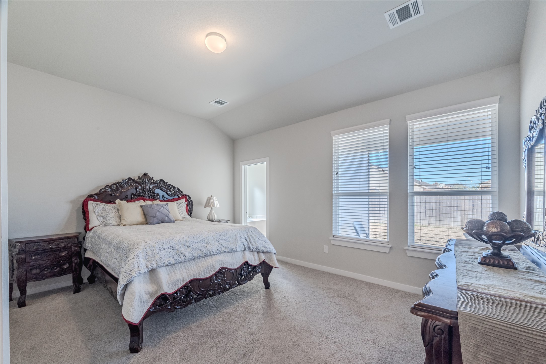 4259 Wyanngate Drive Spring, TX 77373 - Photo 25 of 46 The spacious primary suite is a sun-drenched retreat featuring soaring vaulted ceilings and a wall of windows
