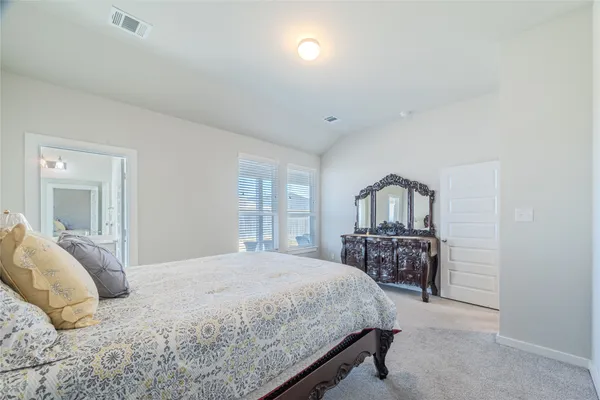 a bedroom with a bed and a table in it