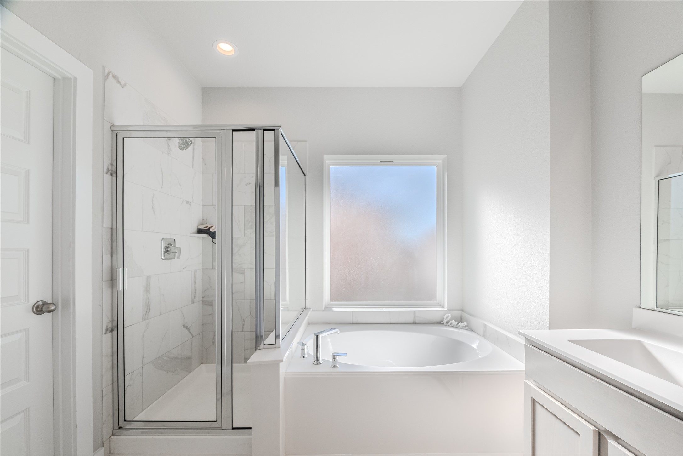 4259 Wyanngate Drive Spring, TX 77373 - Photo 29 of 46 This serene ensuite showcases a glass-enclosed walk-in shower with custom tile work and a relaxing garden tub