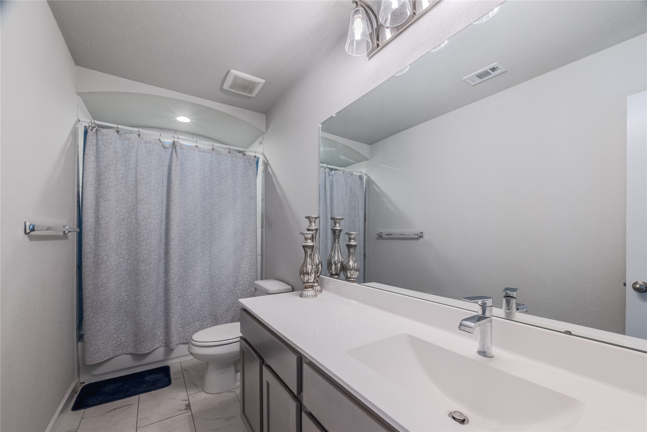 4259 Wyanngate Drive Spring, TX 77373 - Photo 34 of 46 Well-appointed secondary bathroom featuring a spacious vanity, sleek grey cabinetry, and a clean white countertop