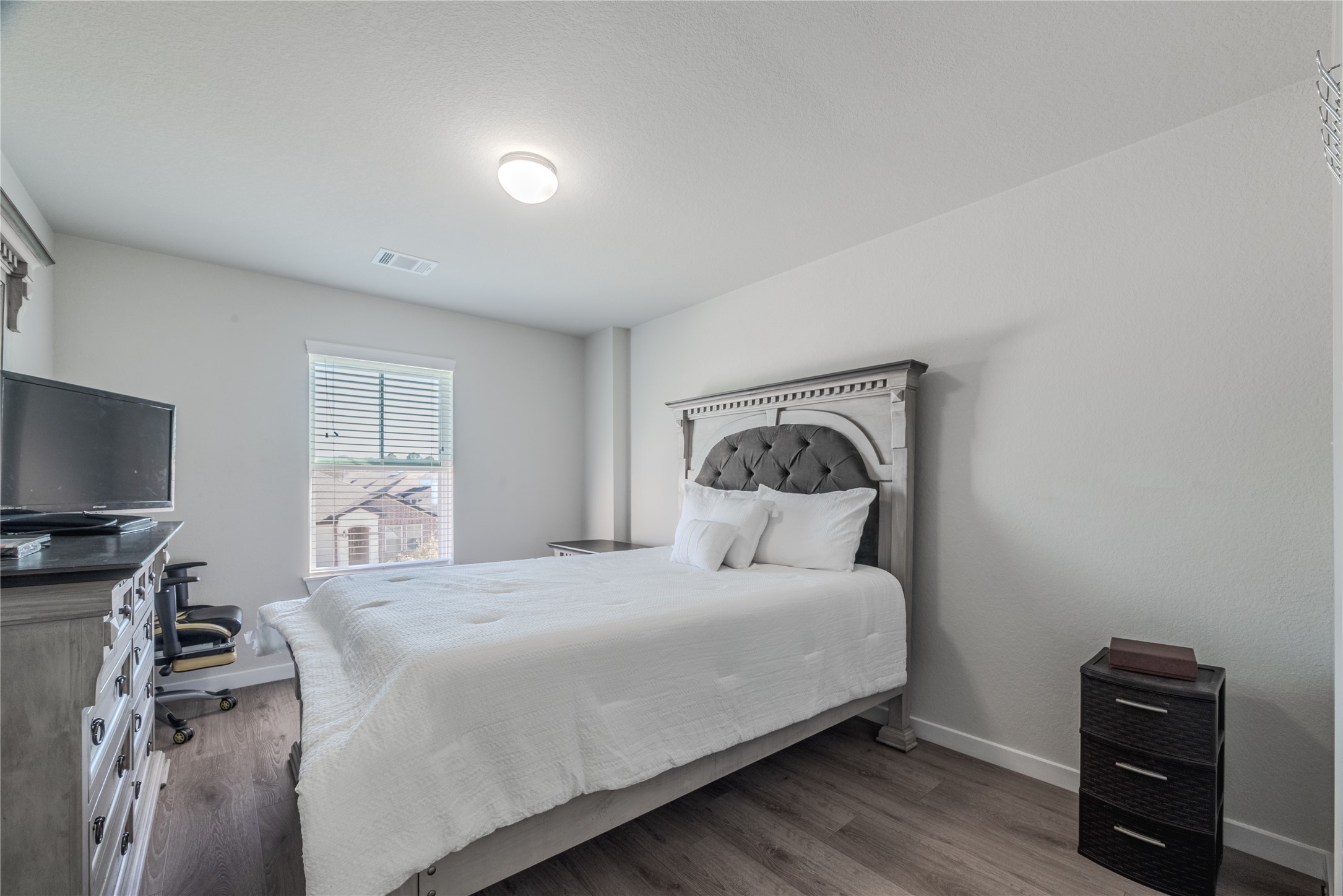 4259 Wyanngate Drive Spring, TX 77373 - Photo 39 of 46 This well-sized bedroom offers a modern aesthetic with sleek flooring and plenty of natural light from the large window.