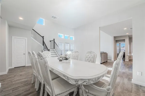 a view of a dining room with furniture and wooden floor