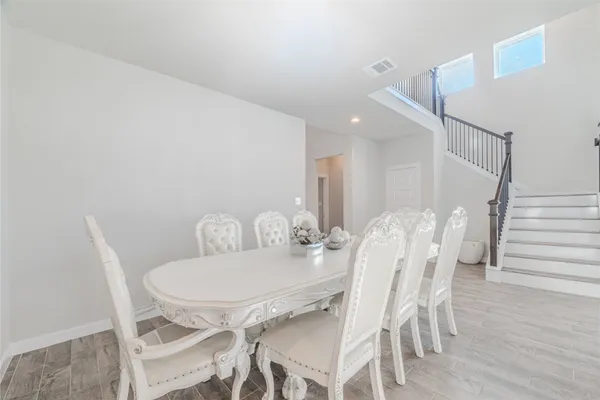 a dining room with furniture and wooden floor