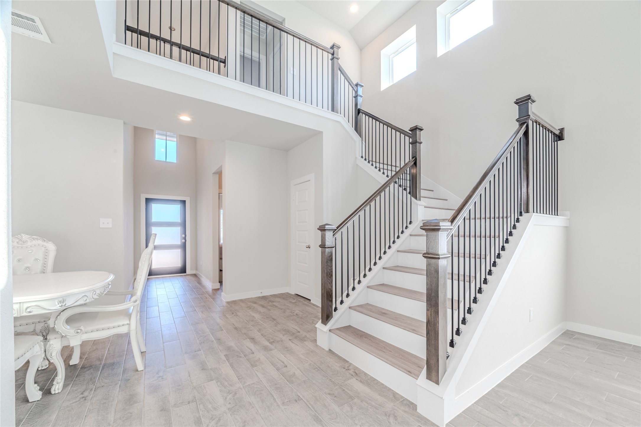 4259 Wyanngate Drive Spring, TX 77373 - Photo 6 of 46 The elegant staircase is accented by a wooden handrail and sleek metal balusters, all illuminated by an abundance of natural light.