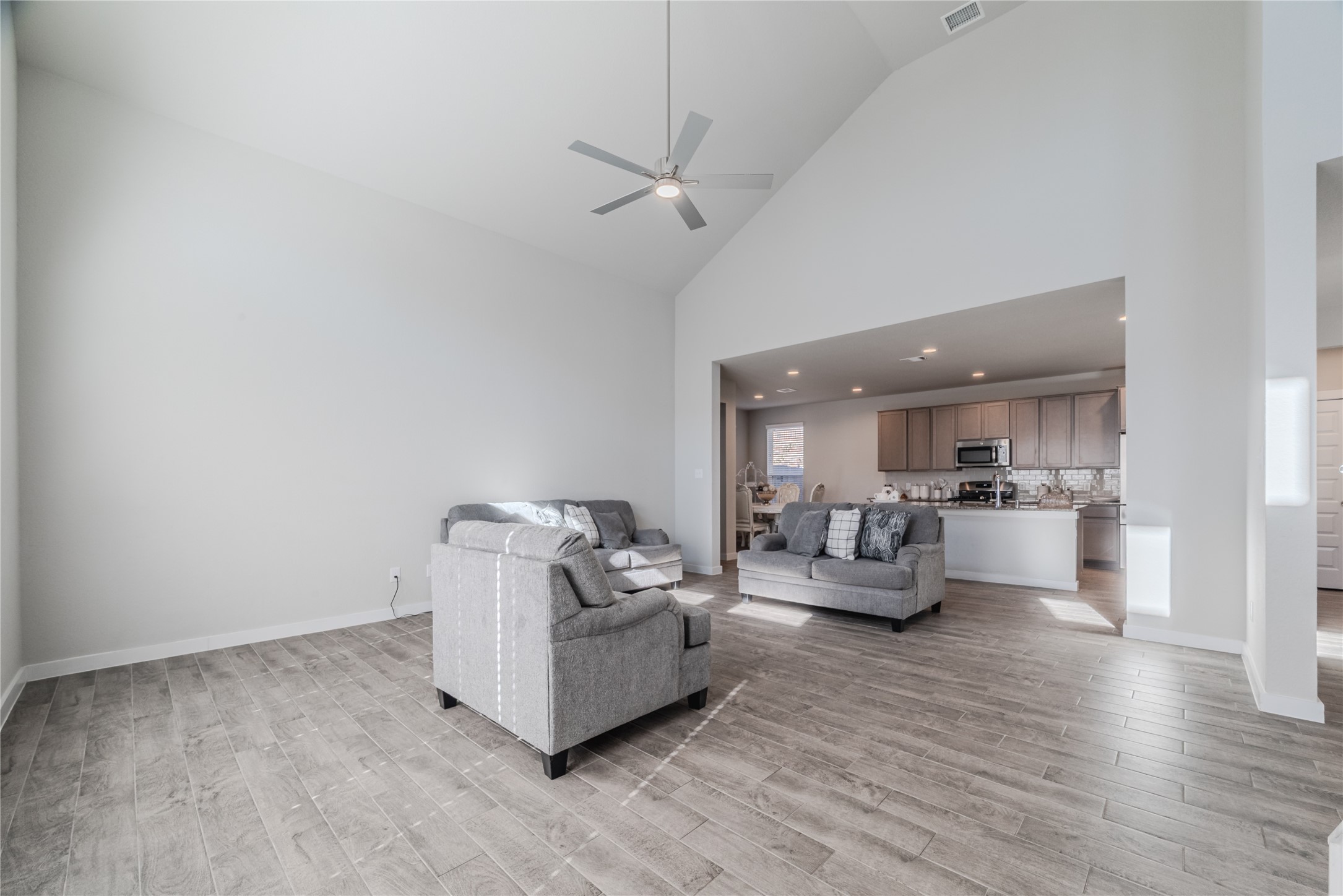 4259 Wyanngate Drive Spring, TX 77373 - Photo 7 of 46 The spacious family room features soaring ceilings and sleek tile flooring, bathed in an abundance of natural light.