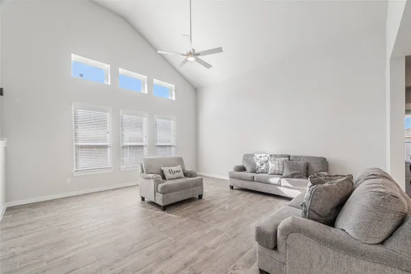 a living room with furniture and stairs