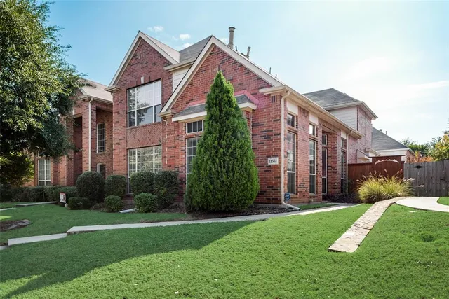 a view of a brick building next to a yard