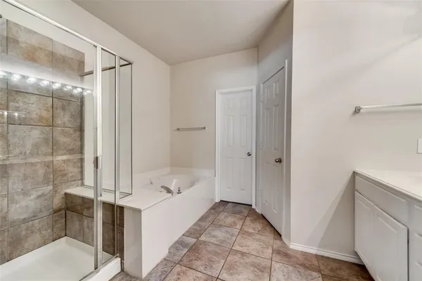 a bathroom with a bathtub and a shower